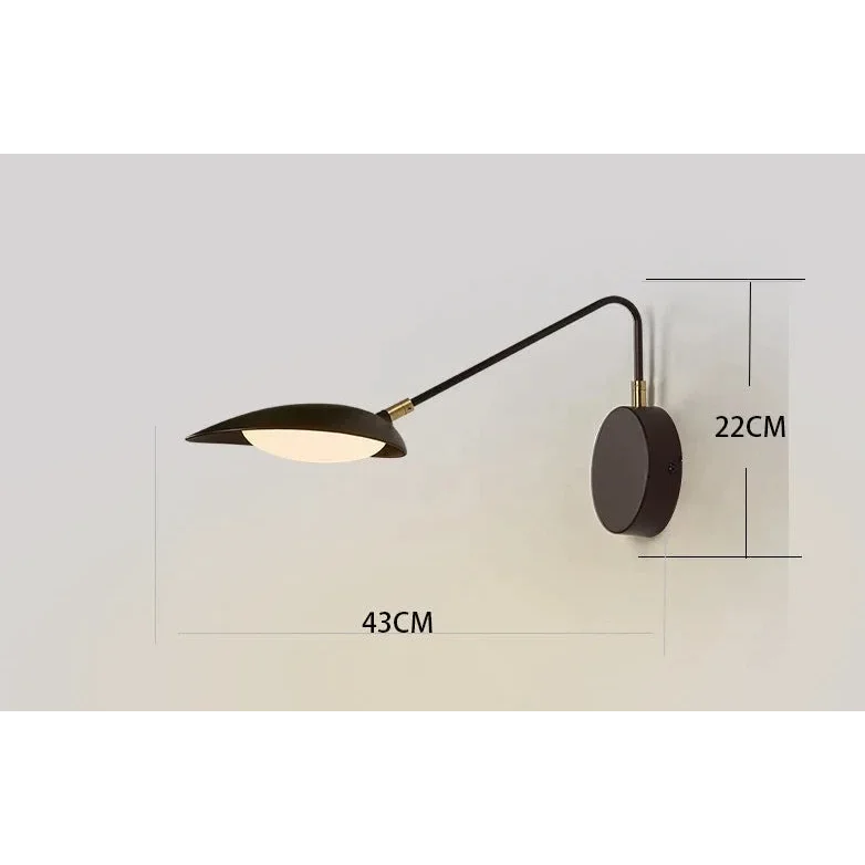 Swing-arm sconce angled to wash a wall
