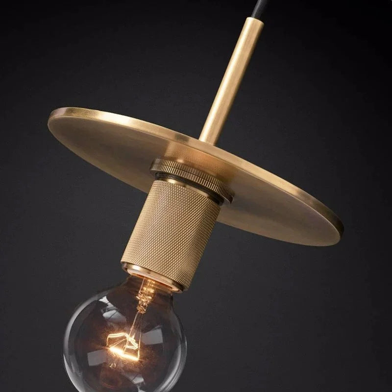 Brass disc pendant in a living space