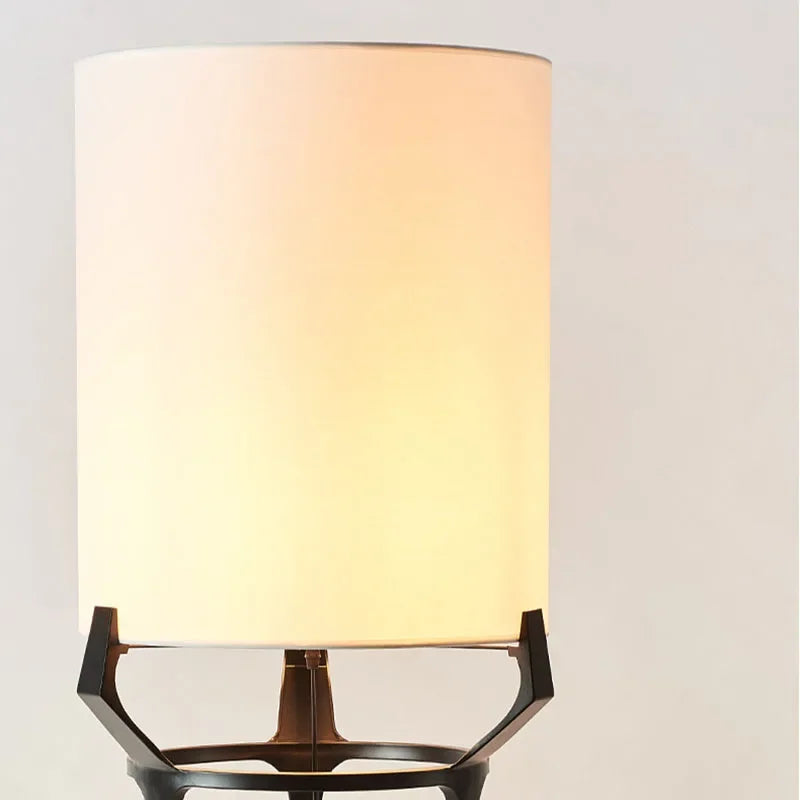 Elegant floor lamp with white shade glowing warm