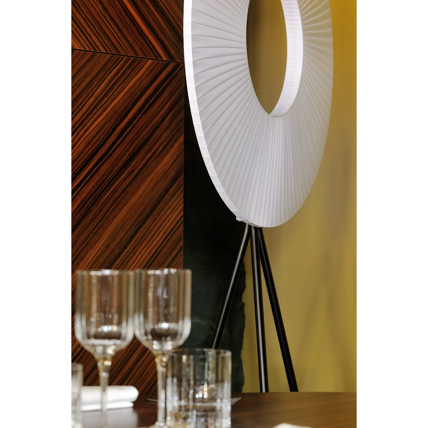 Hand-knitted fabric shade on a slim floor lamp