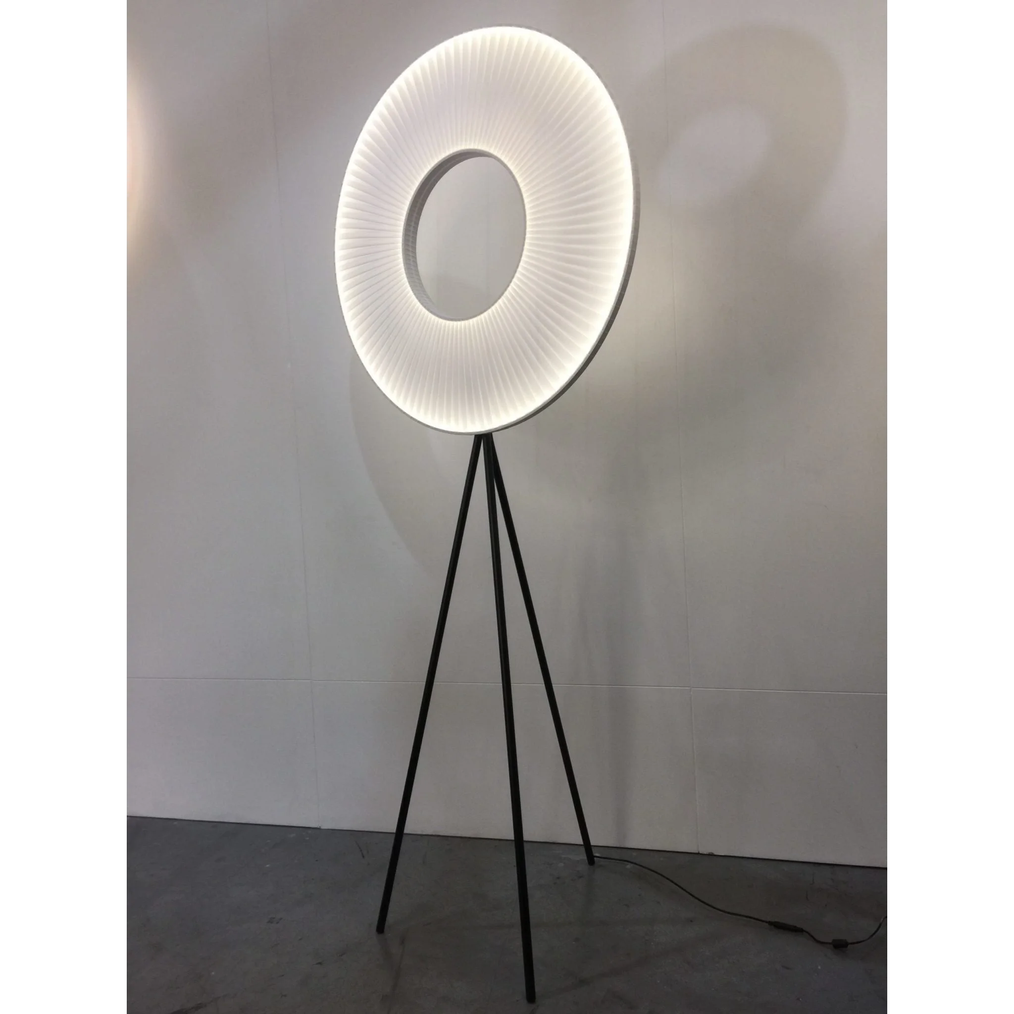 Modern halo floor lamp with a knitted fabric shade in a living room