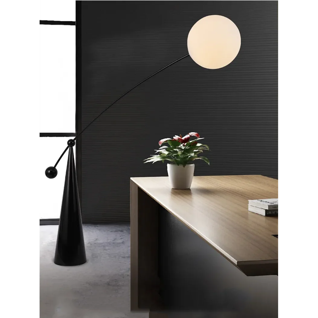 Frosted glass globe on an arc floor lamp