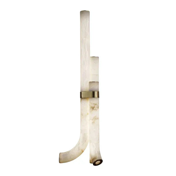 Alabaster and brass floor lamp glowing warm in a living room