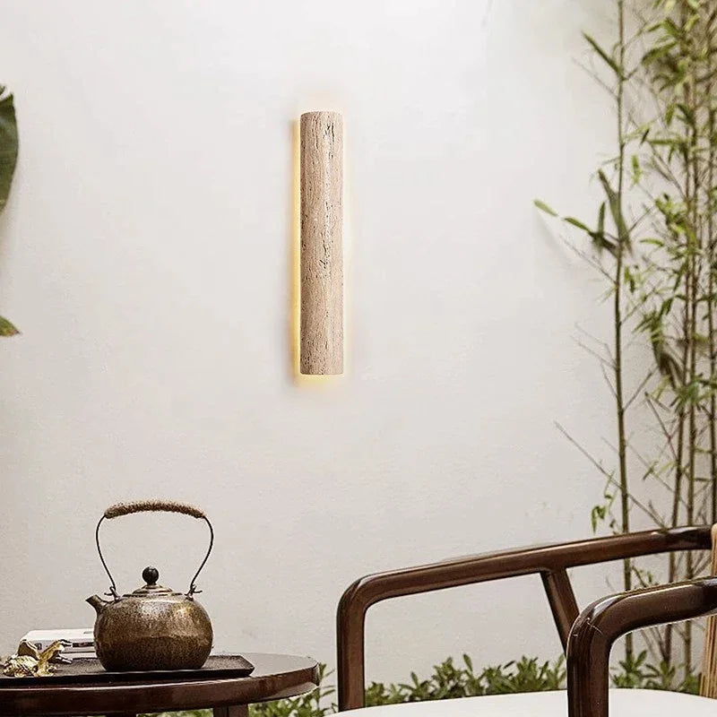 Travertine sconce casting an earthy ambient glow