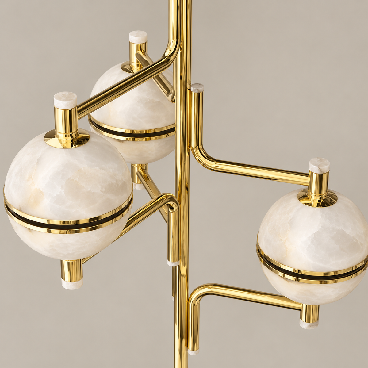 Cloudy alabaster globes, brass bands and curved arms of the Orbital chandelier.