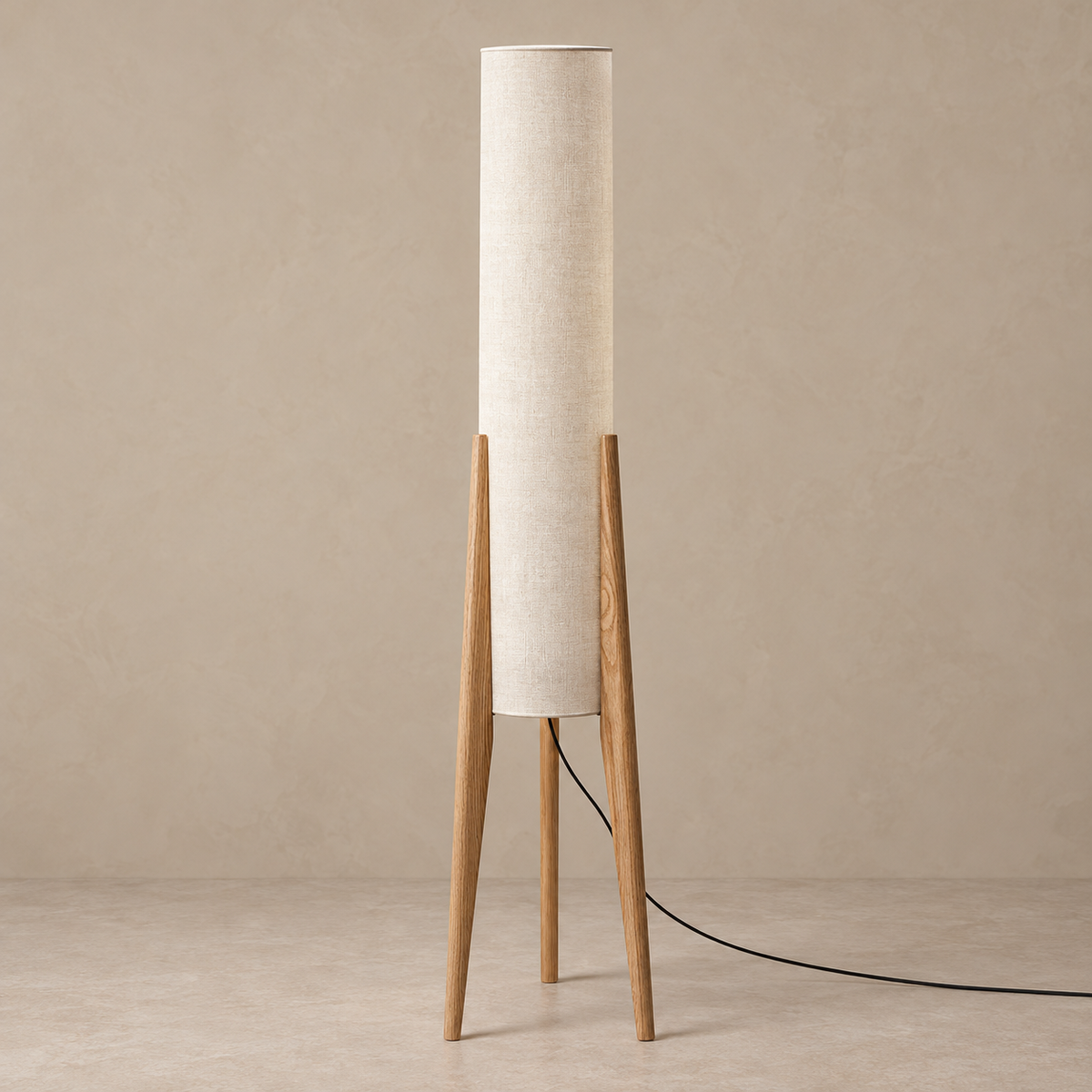 Piloni floor lamp with natural wood tripod and cylindrical linen shade, switched off.