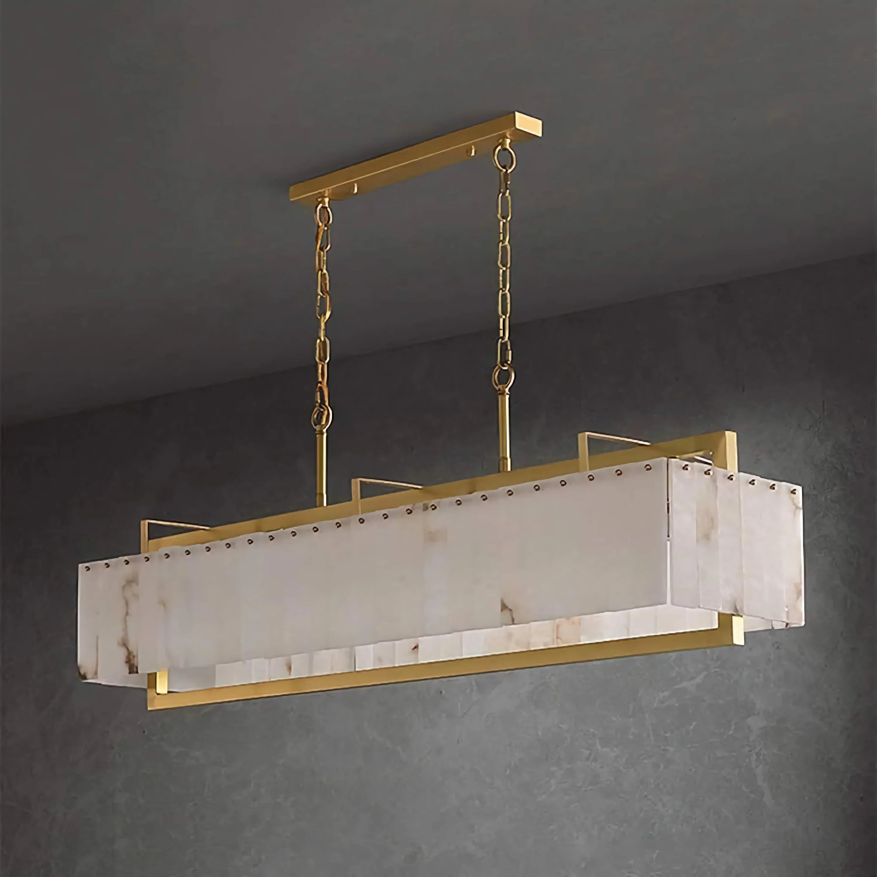 Scrigno alabaster and brass cage chandelier over a dining table