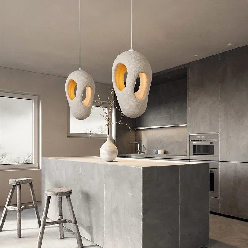 Brushed-nickel-toned resin pendant in a kitchen