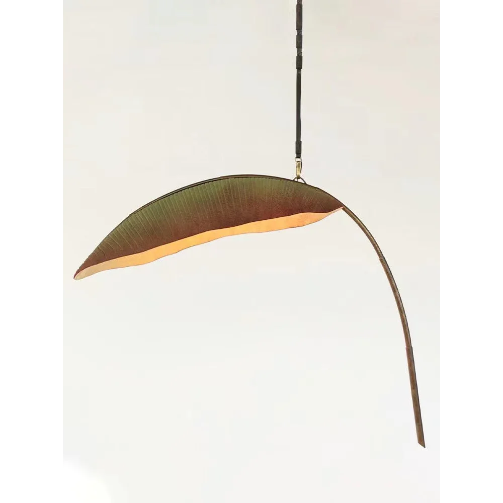 Banana leaf pendant casting warm indirect light