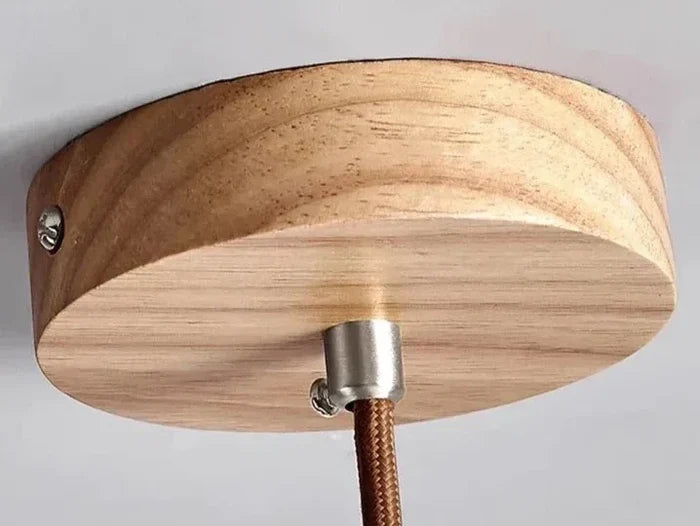 Wooden ceiling canopy and brown suspension cord of the Slim Stone pendant.
