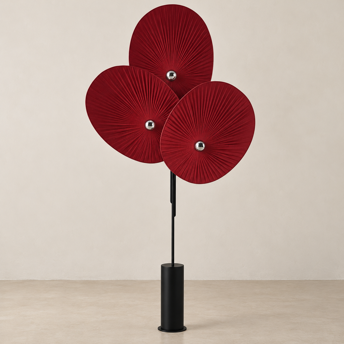 Red Svelo floor lamp showing three pleated fabric shades and silver-capped bulbs.