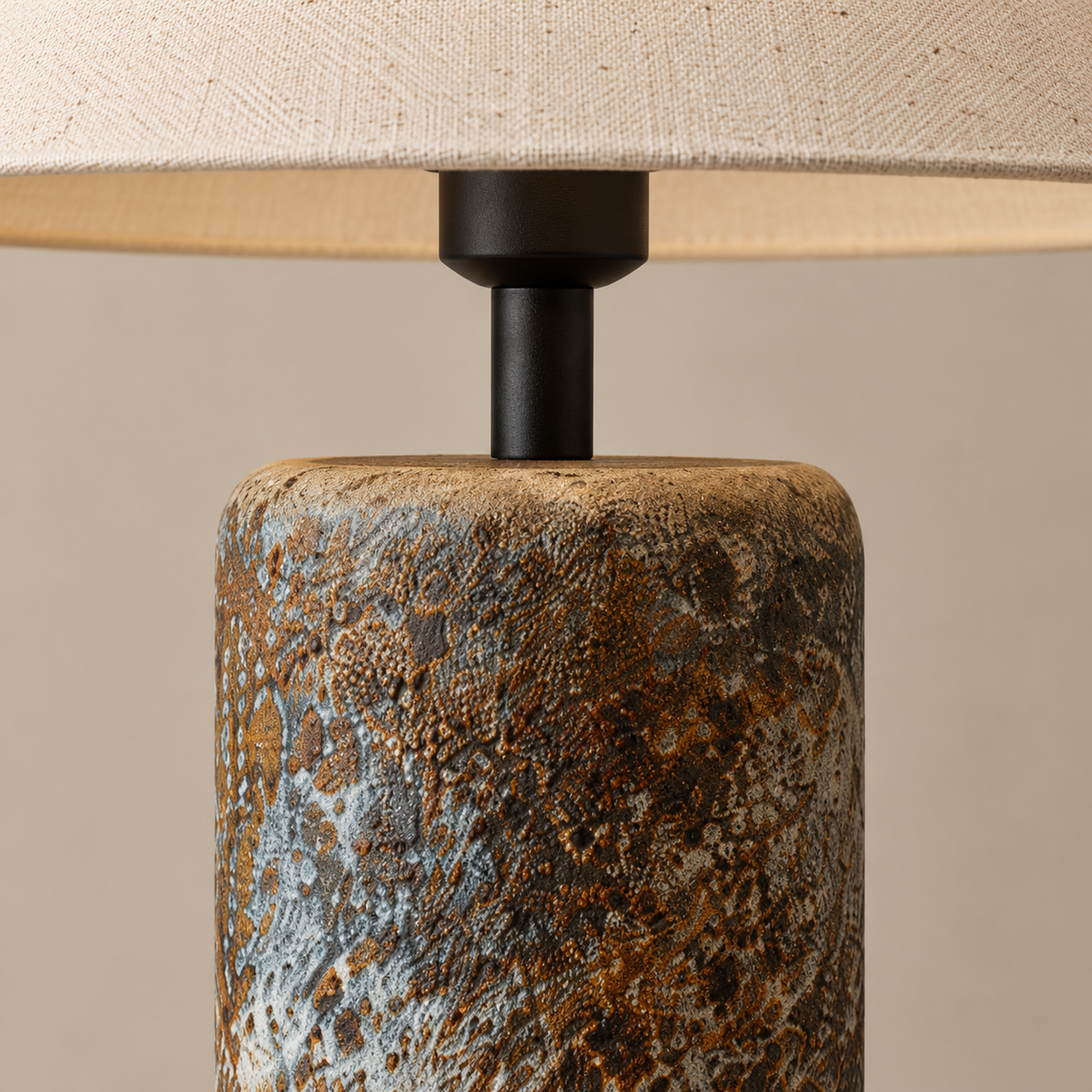 Mottled ceramic column and black neck detail of the table lamp