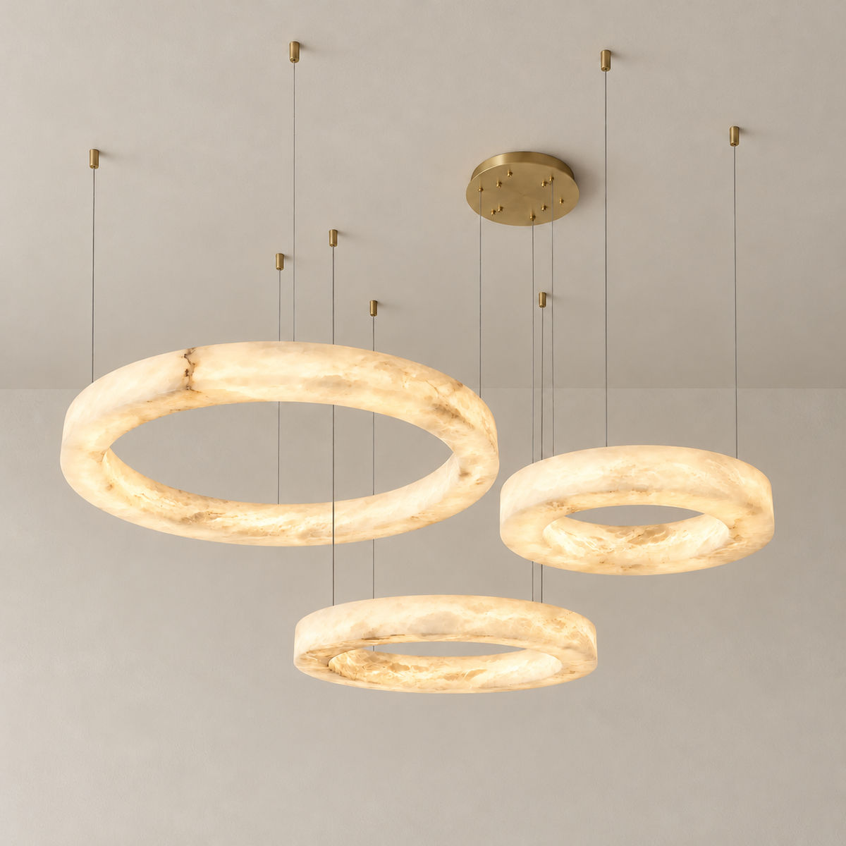 Triplo chandelier illuminated through its three naturally clouded alabaster rings.