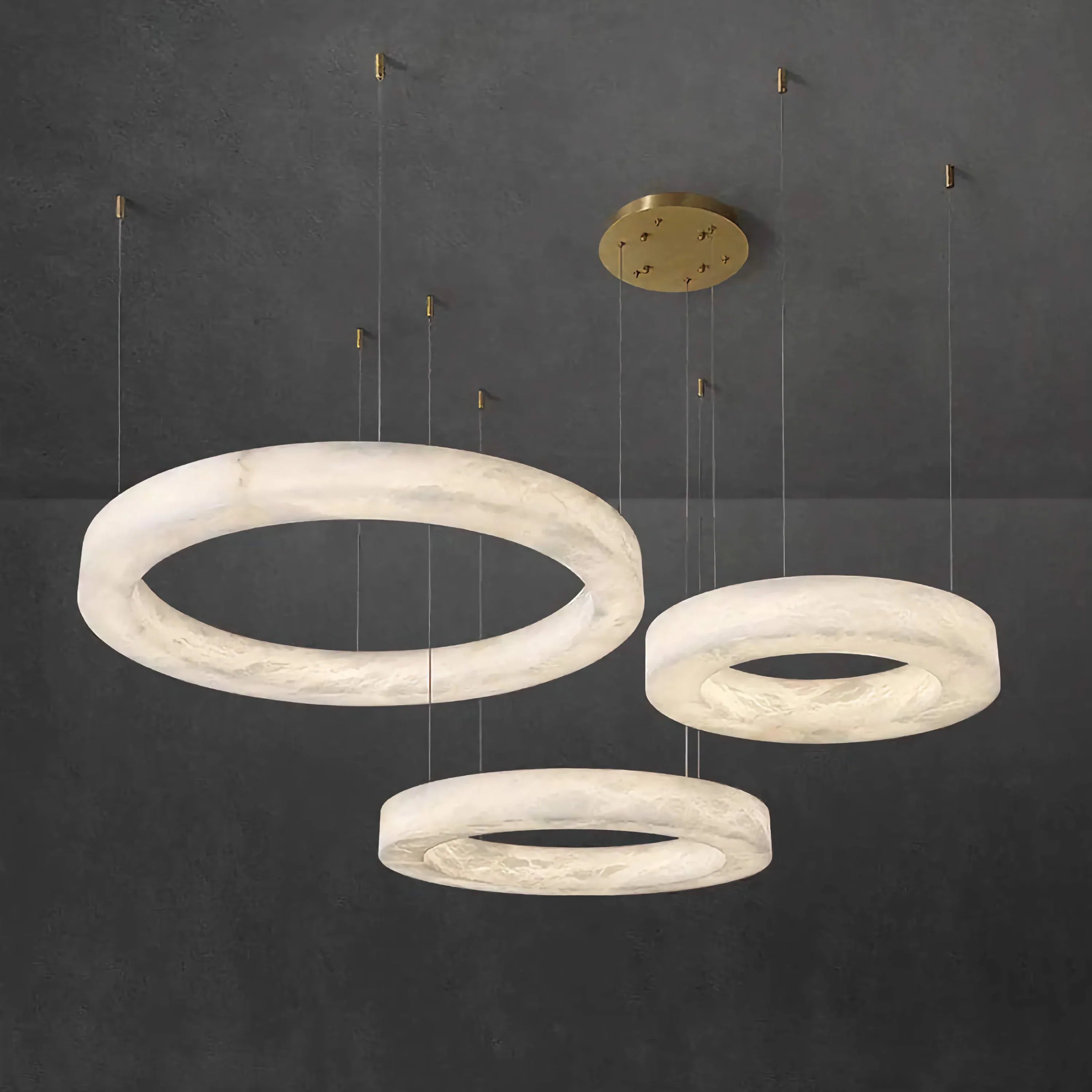 Triplo triple-ring alabaster chandelier over a dining table