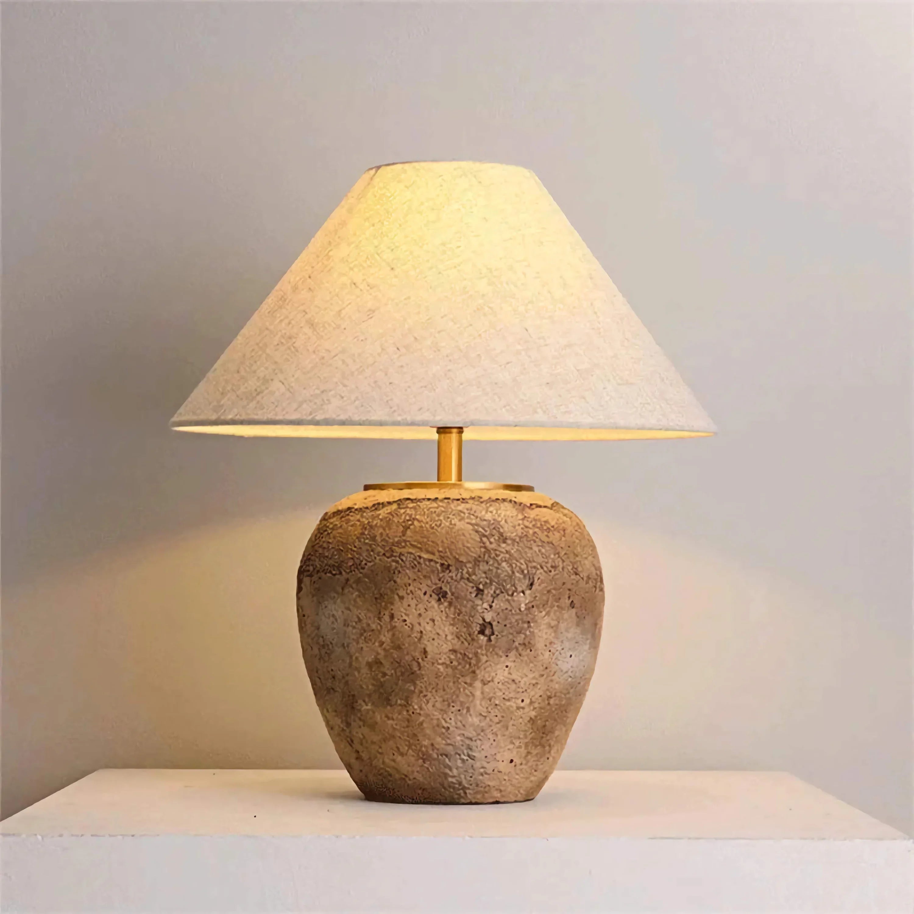 Taupe stone-look ceramic lamp on a console