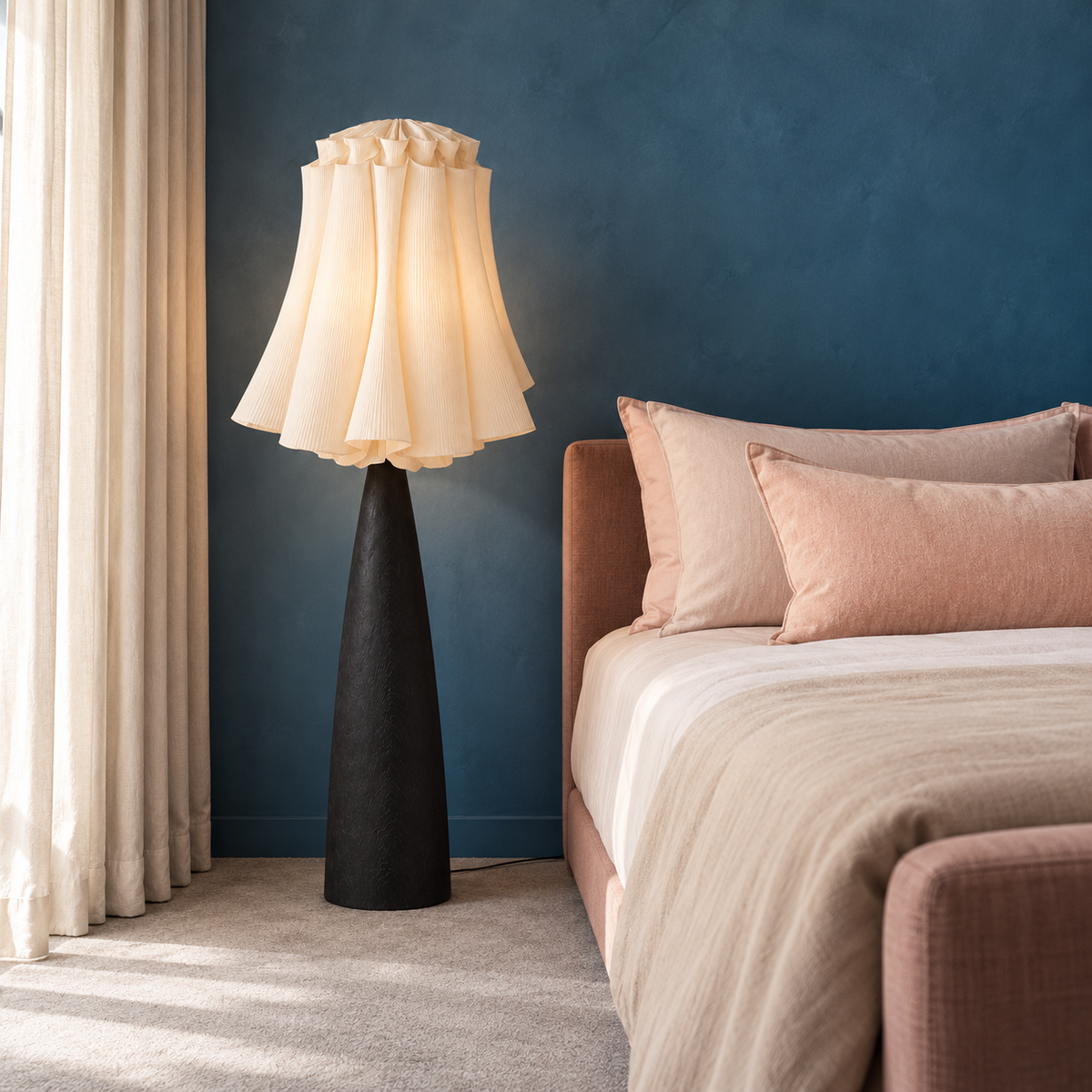 Viterbo floor lamp beside a blush upholstered bed in a blue bedroom with linen curtains.