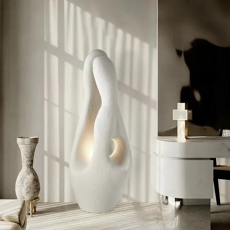 Sculptural resin standing lamp with warm light