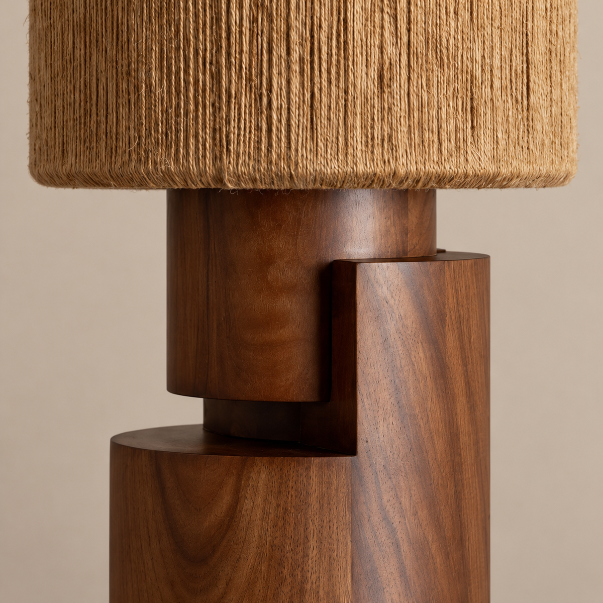 Close view of the sculptural walnut base and natural-fibre shade.