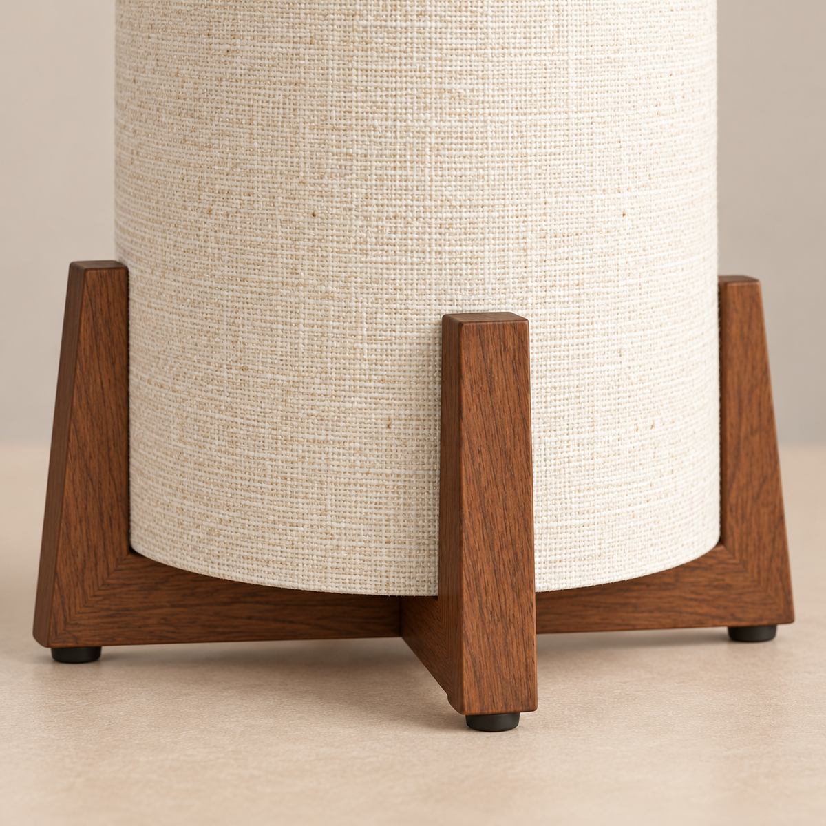 Linen shade and crossed wood support detail of the table lamp