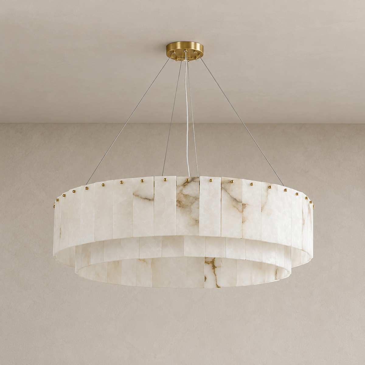 Unlit two-tier alabaster drum chandelier with brass fittings and natural stone veining.