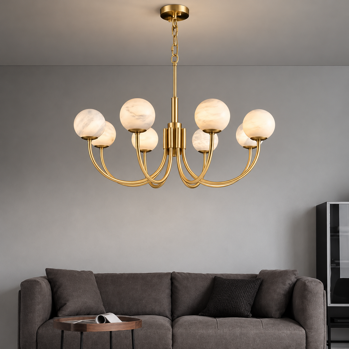 Eight-globe alabaster chandelier above a grey sofa in a naturally lit living room.