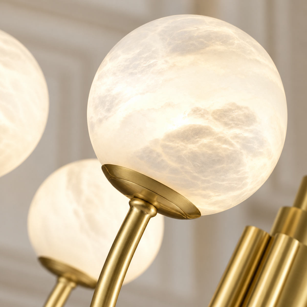 Close view of natural cloudy alabaster and the chandelier’s brass globe cup.