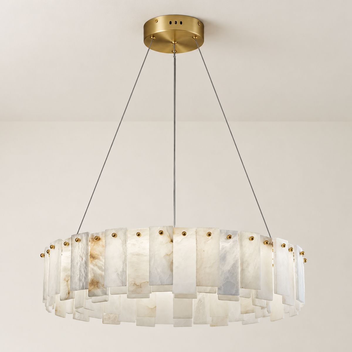 Alabaster ring chandelier unlit, with natural varied stone panels and brass fixings.