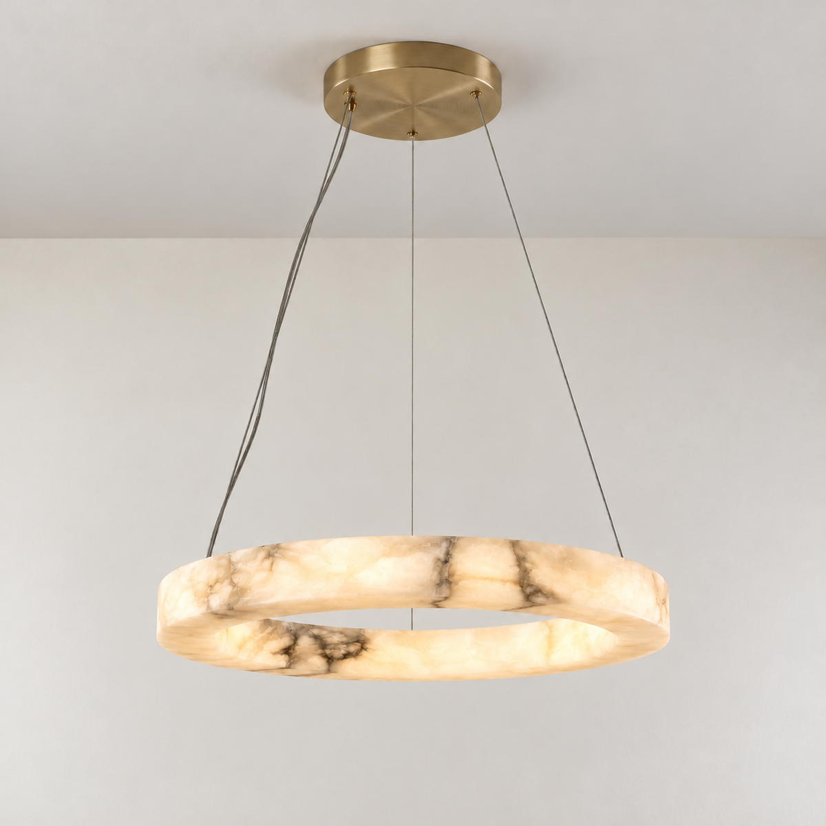 Anello alabaster ring chandelier illuminated, showing cloudy stone and natural veins.