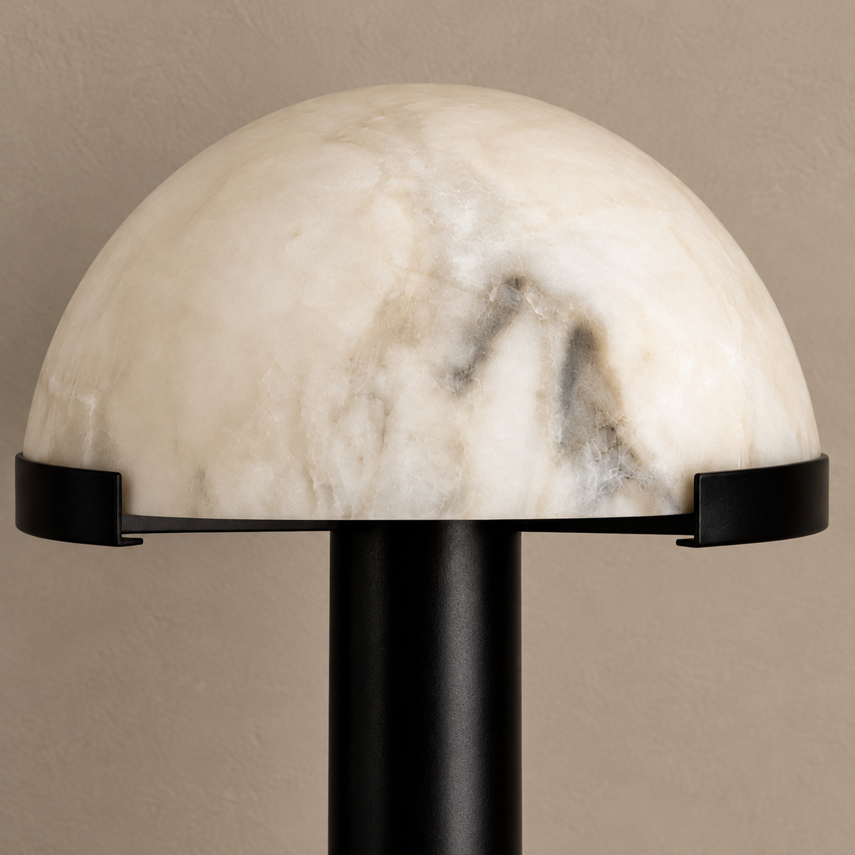 Close-up of alabaster stone and black dome retaining brackets.