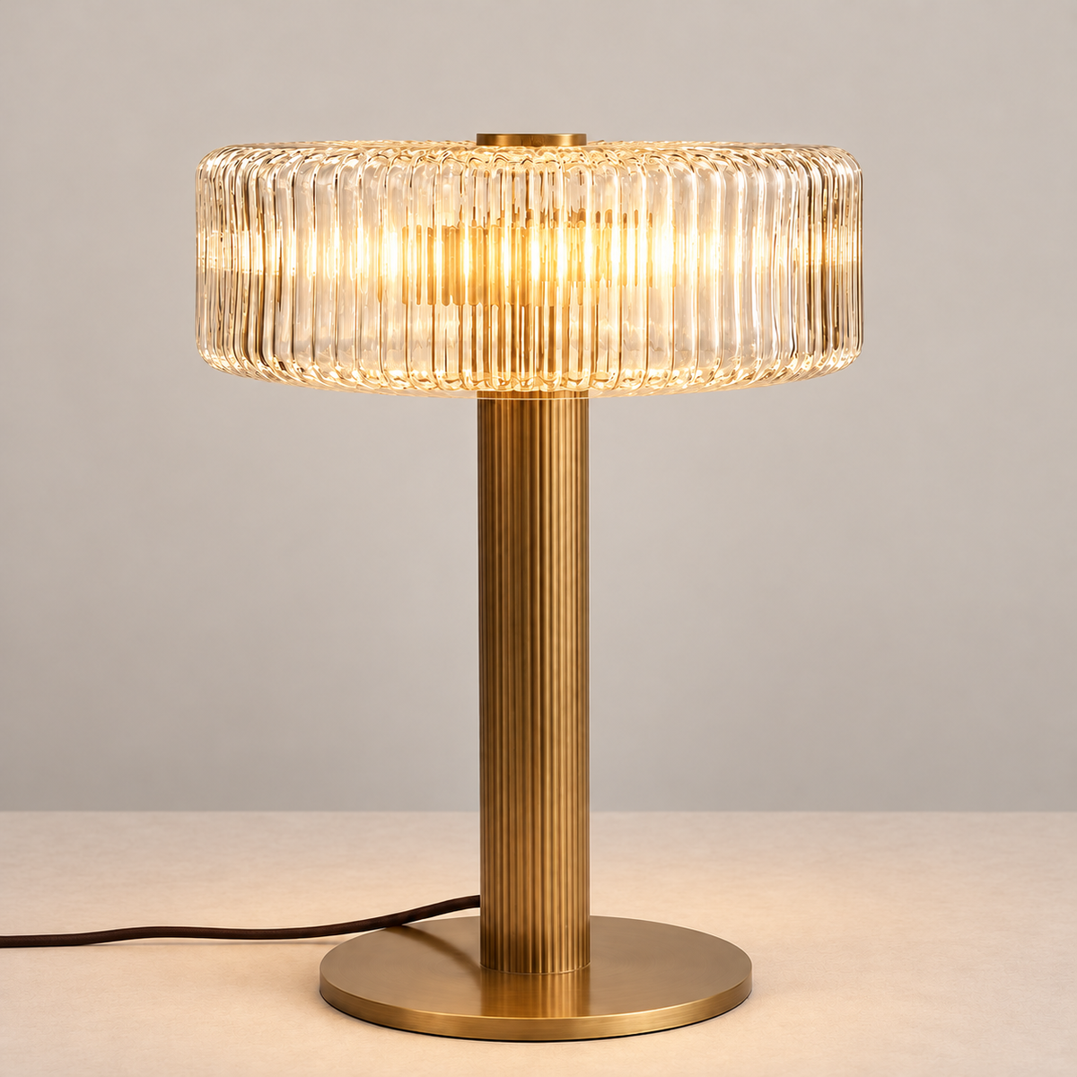 Ribbed glass and brass table lamp illuminated