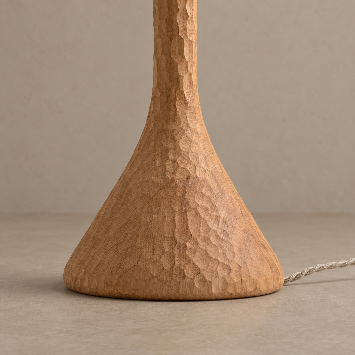 Close view of the CL70ZZ flared oak base, showing carved facets, wood grain and twisted cord.
