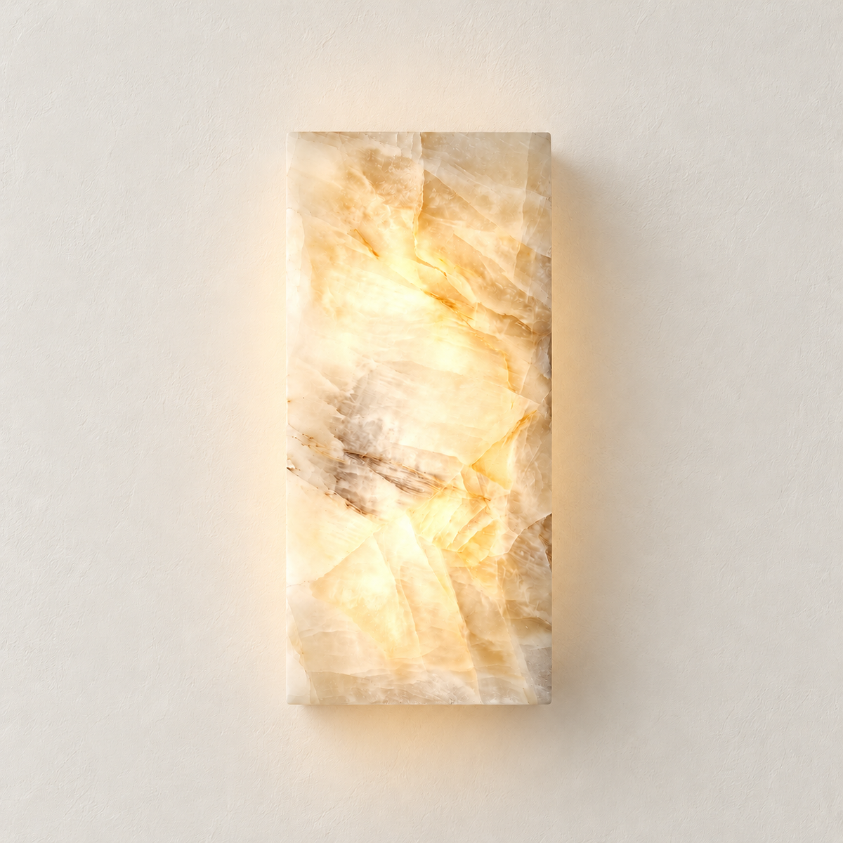 The 30 cm alabaster column wall lamp illuminated on an ivory wall.