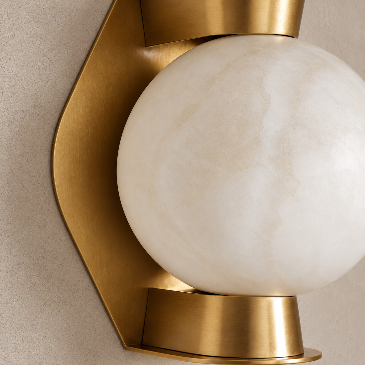 Alabaster globe and brass wall sconce, close view of the shade and brass support