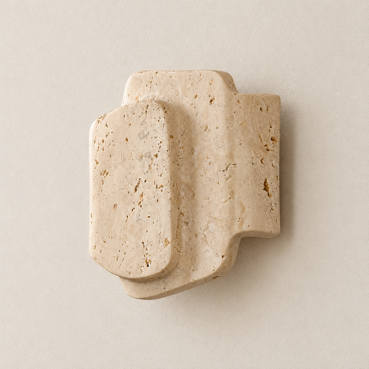 Angled view showing the depth and stepped edges of the layered travertine sconce.