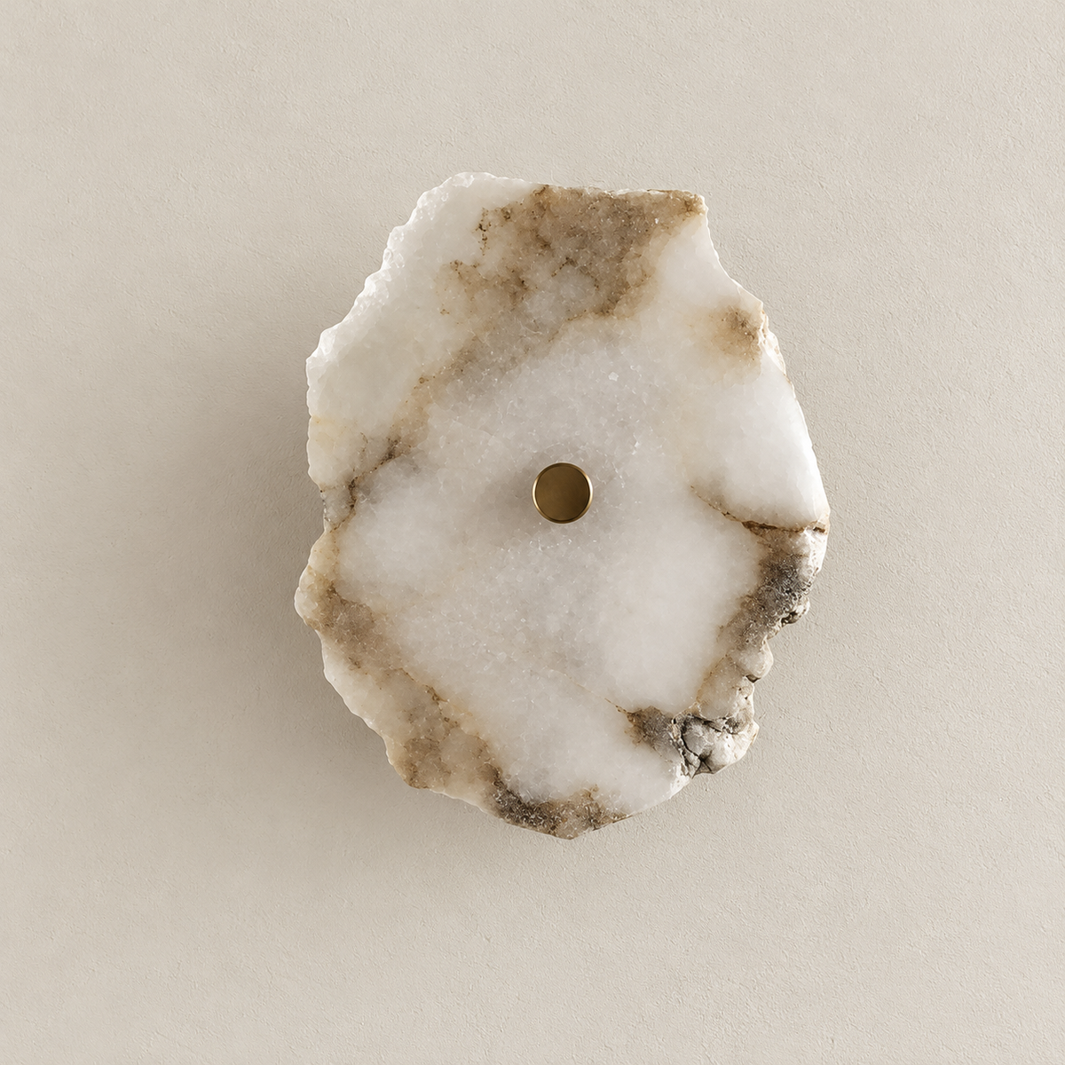 Unlit single-stone wall sconce with a rough natural marble edge and a central brass cap.