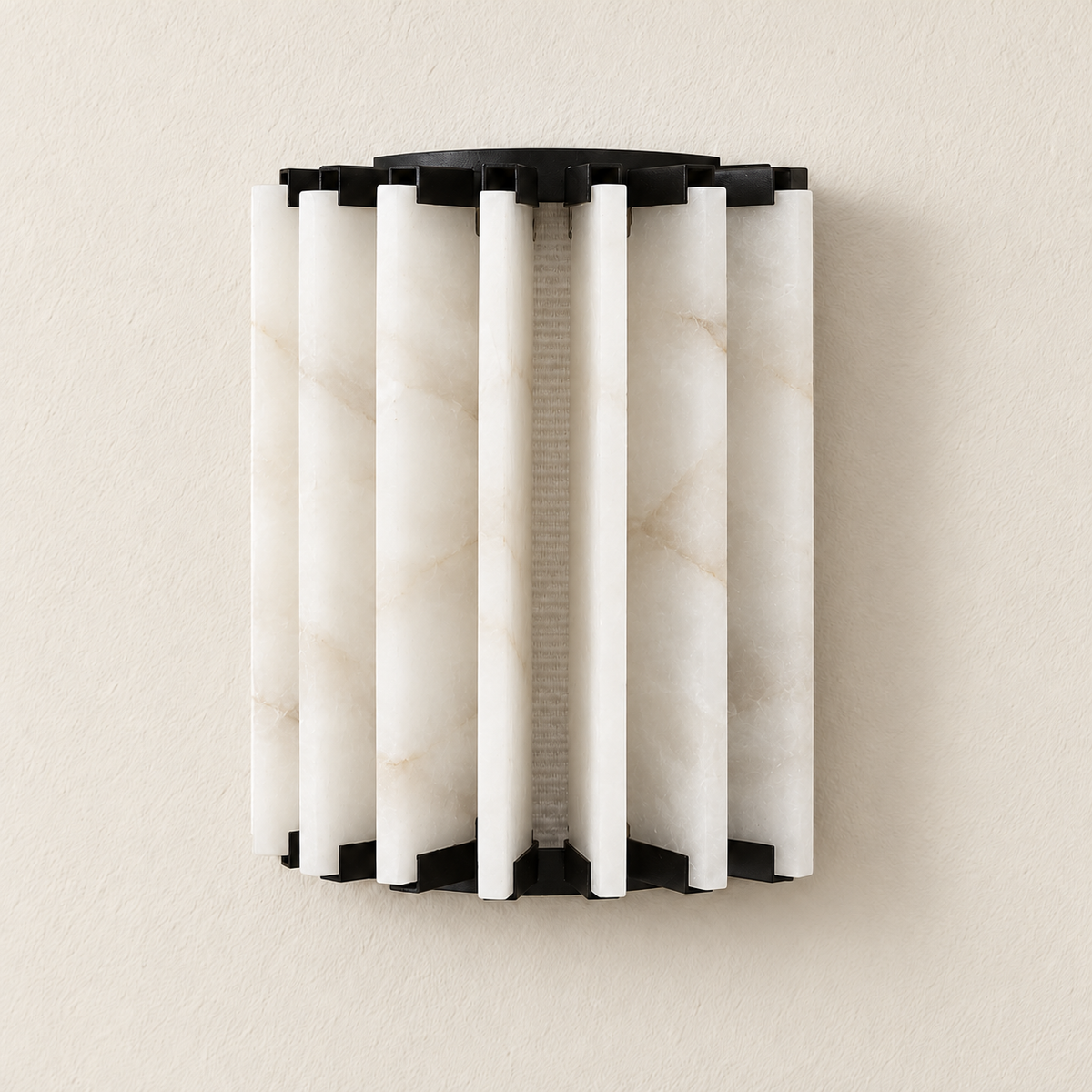 Ribbed alabaster wall sconce with black iron brackets, switched off on ivory plaster.