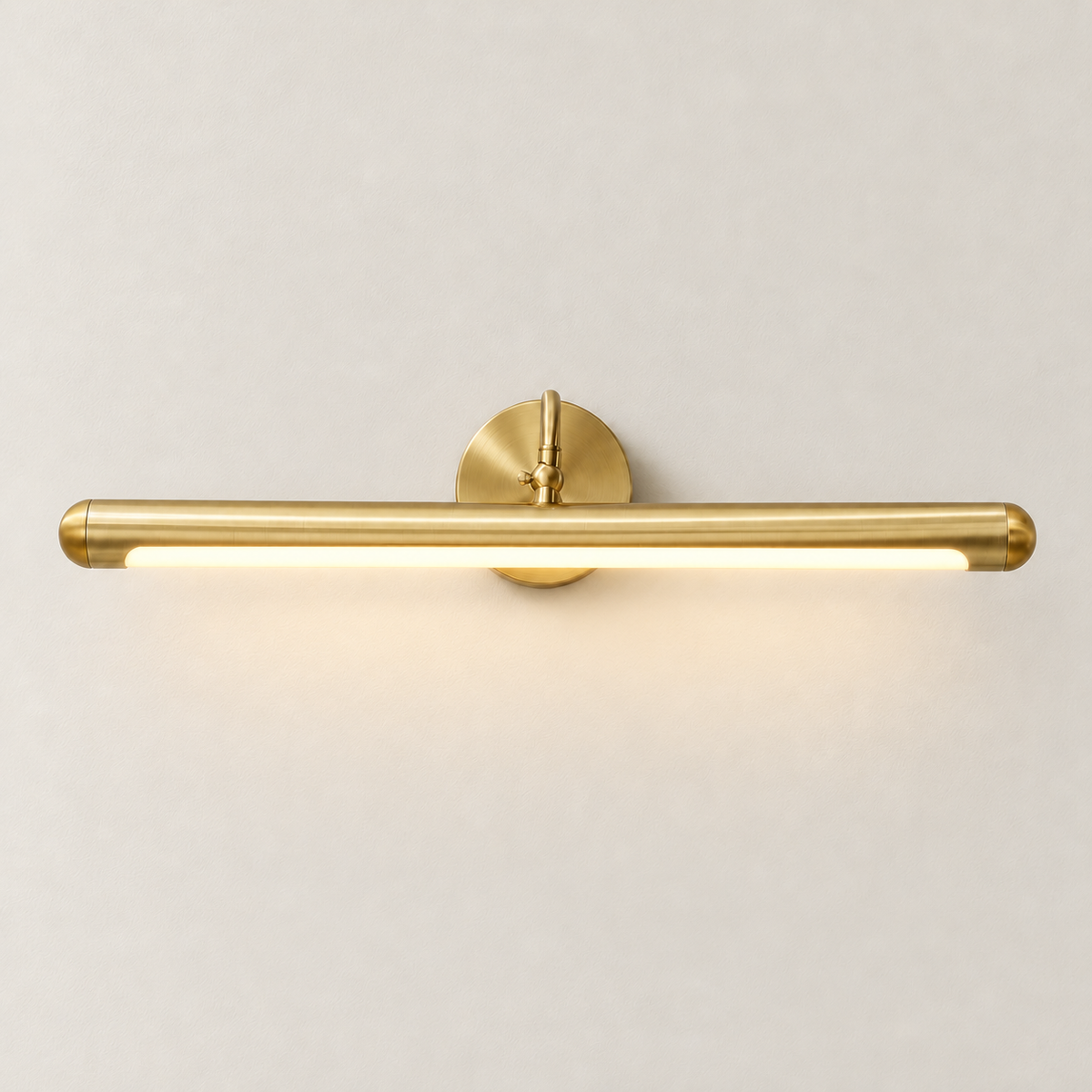 Brass picture light with its underside LED illuminated.