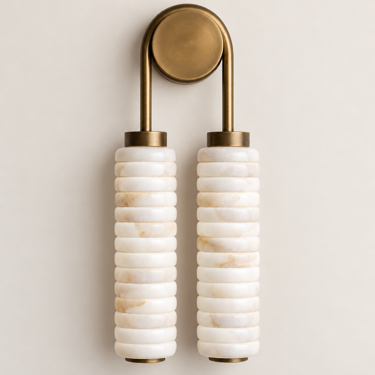 Close-up of the double marble sconce's ribbed stone shades and brass fittings.