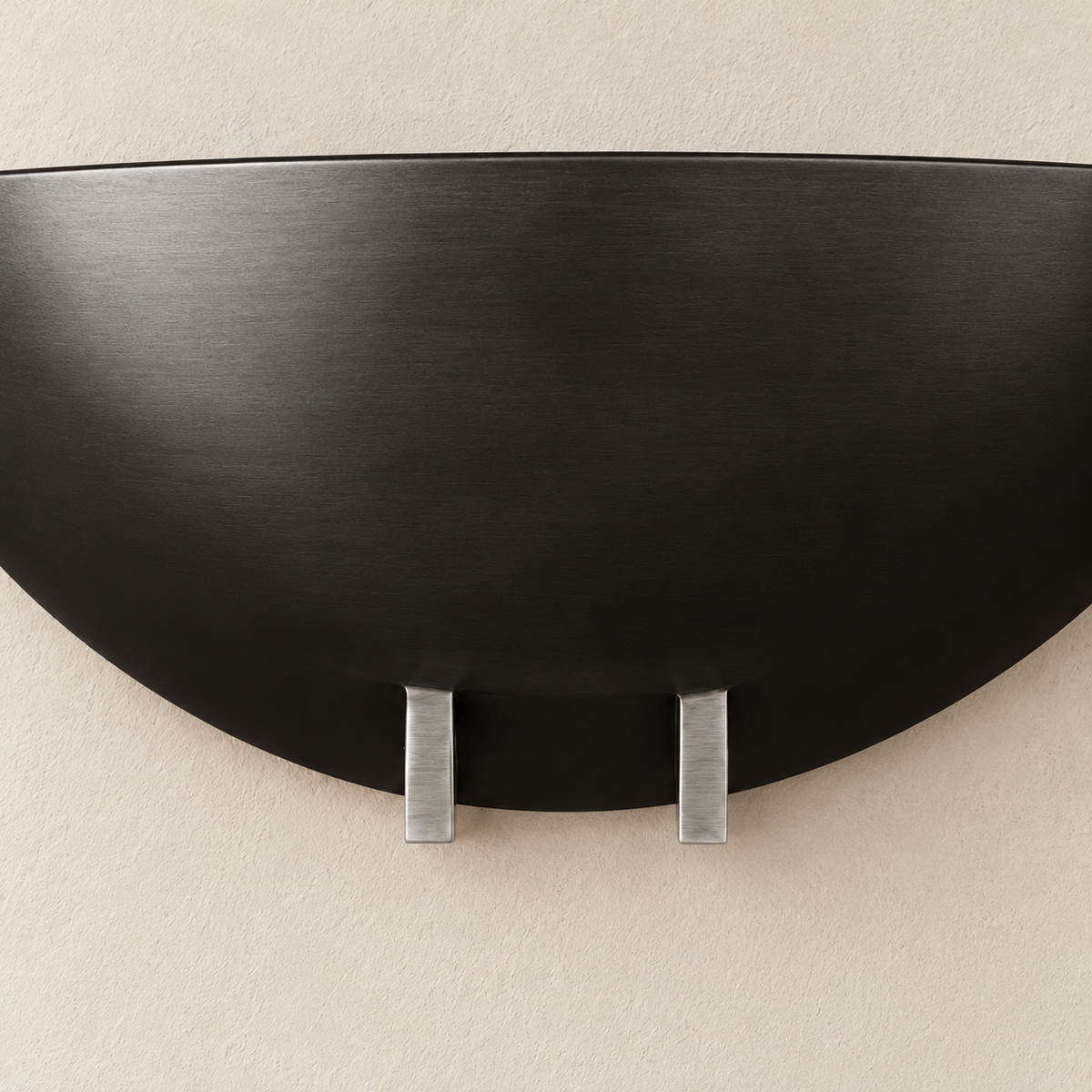 Black bowl wall sconce showing its material and mounting detail.