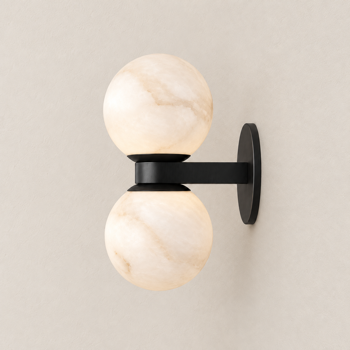Side view of the double alabaster globe sconce showing its black supporting arm.