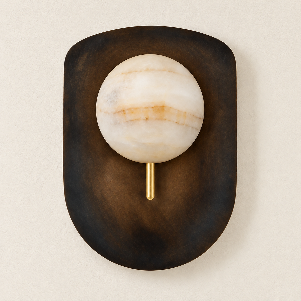 Alabaster brass shield wall sconce mounted on ivory plaster, switched off.