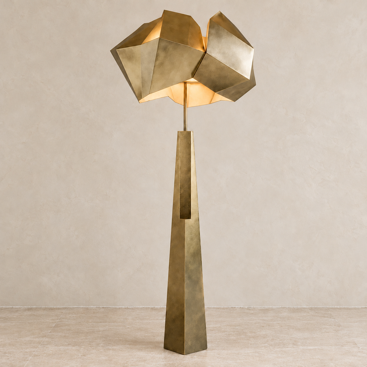 Aventine Antique Gold floor lamp illuminated against a light beige background.