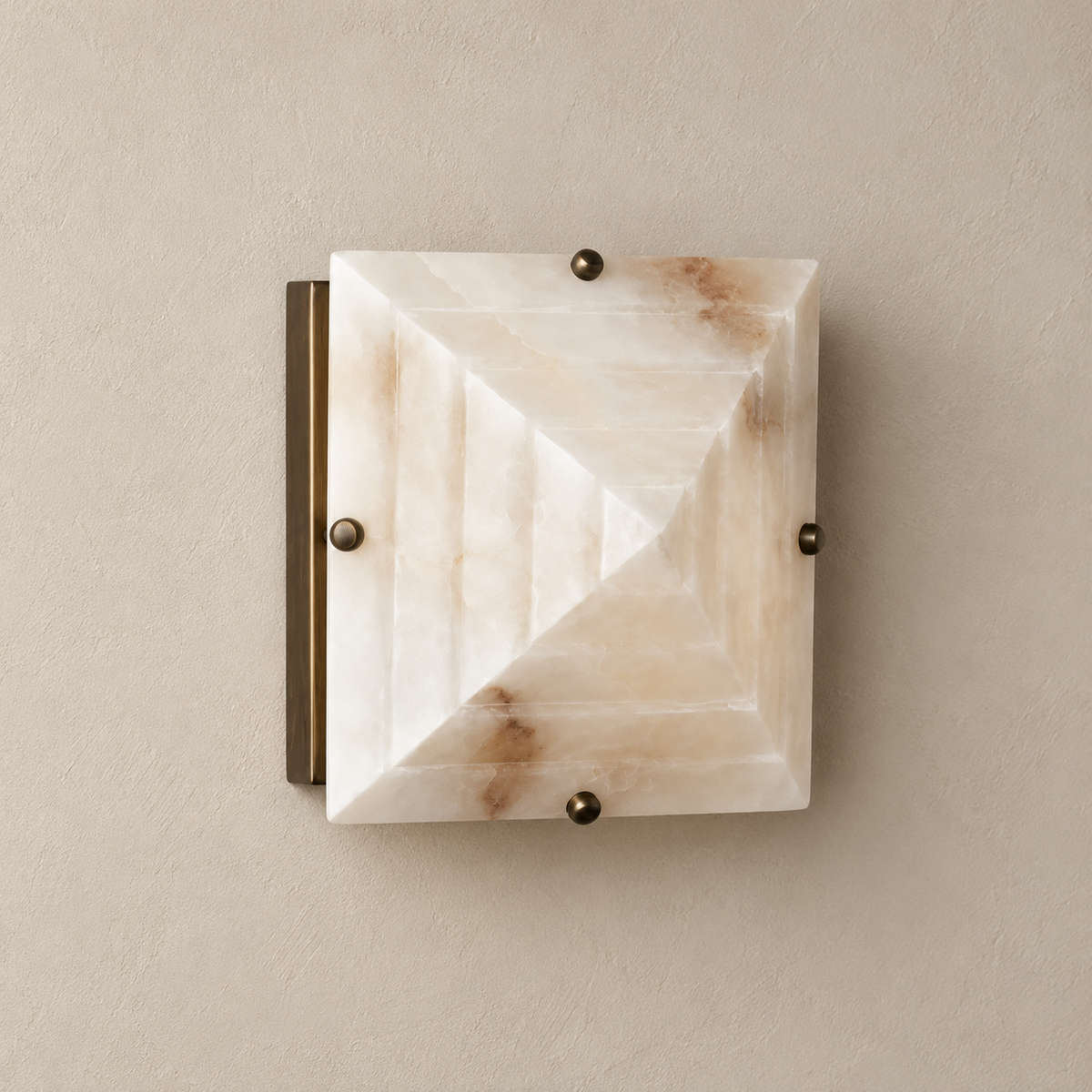 Stepped square alabaster wall sconce with brass fixing caps, switched off.