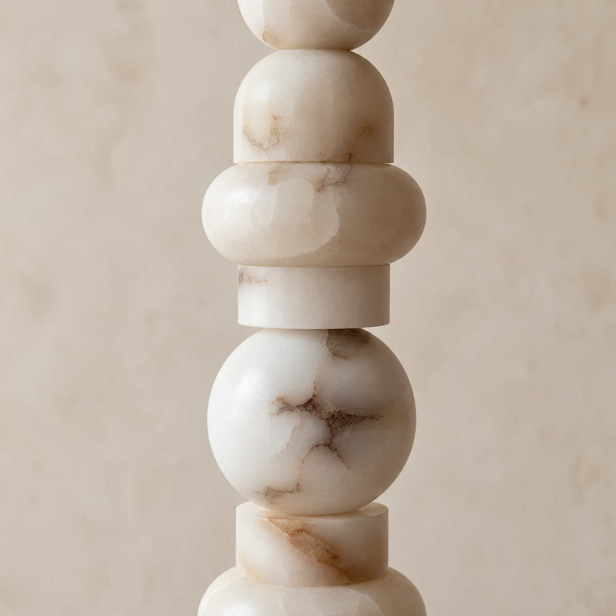Close view of the Grenaldi lamp's rounded alabaster forms, cloudy layers and natural mineral inclusions.