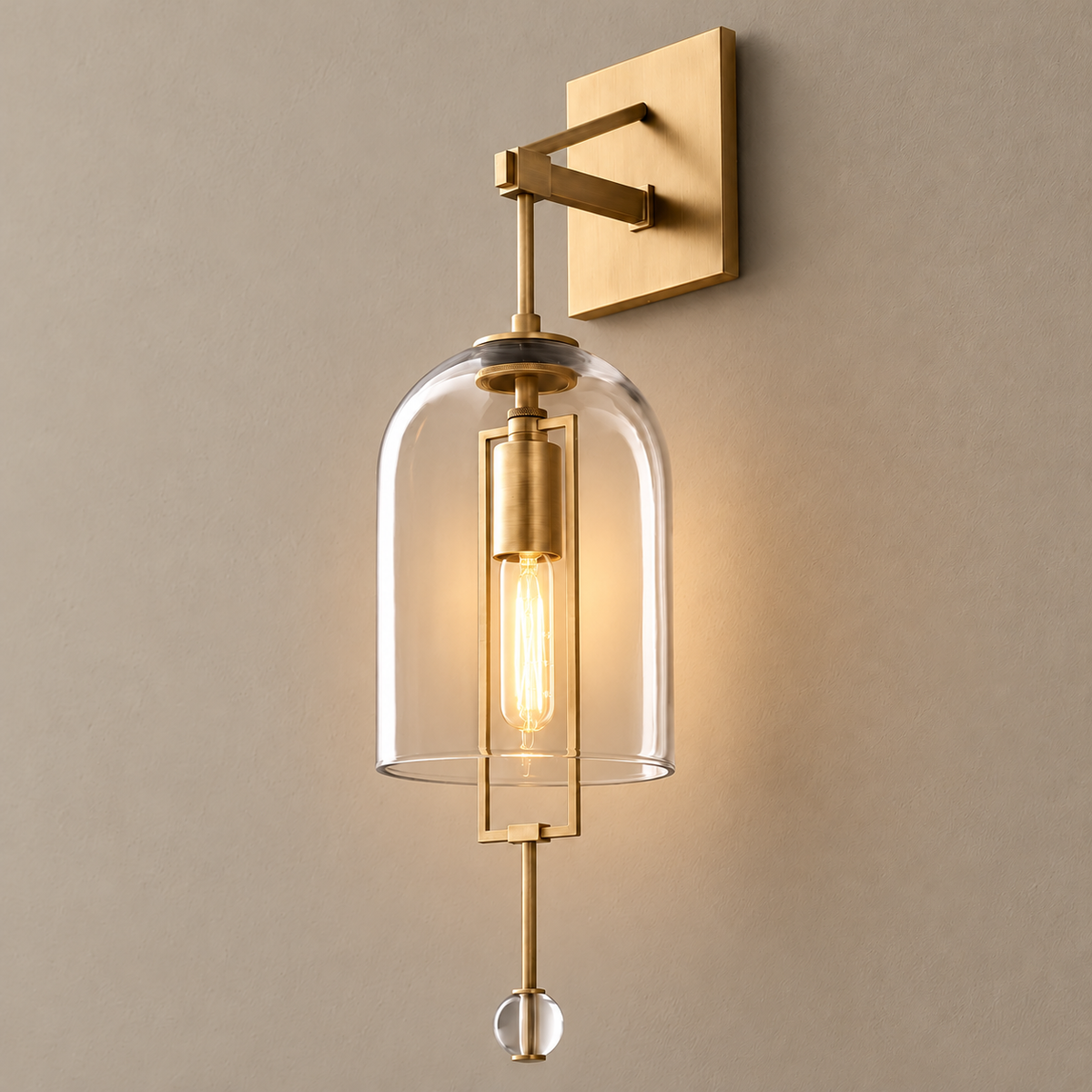 Clear glass bell wall sconce, illuminated on a stone-beige wall