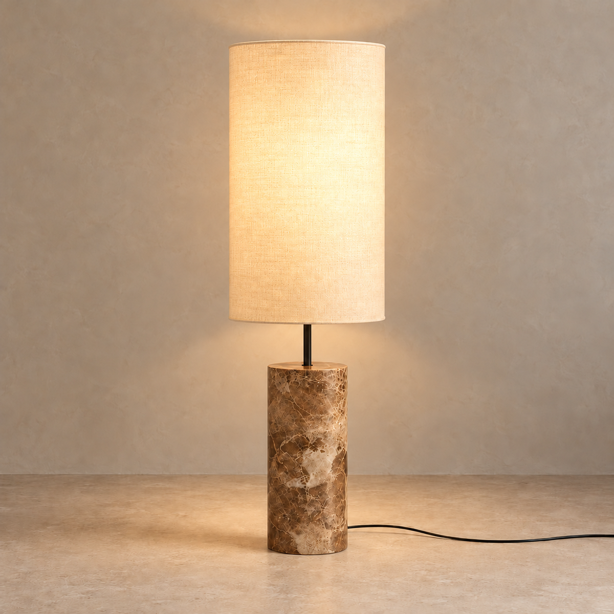 CLMARBHS45 floor lamp illuminated, with the fabric shade glowing above the veined marble base.