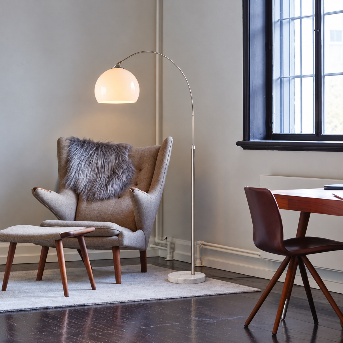 White CLOPO8950 arc lamp beside a grey wingback chair and black-framed window