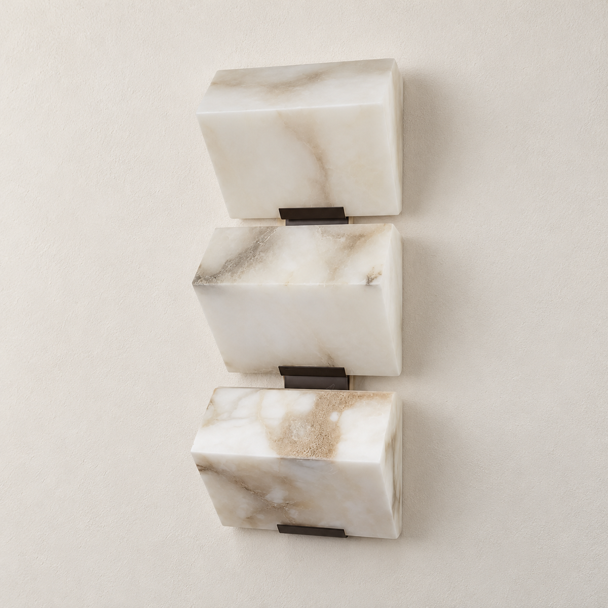 Triple alabaster block wall sconce with black supports, switched off.