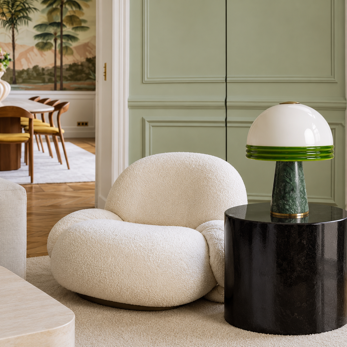 Green marble table lamp beside a cream chair in a sage living room.