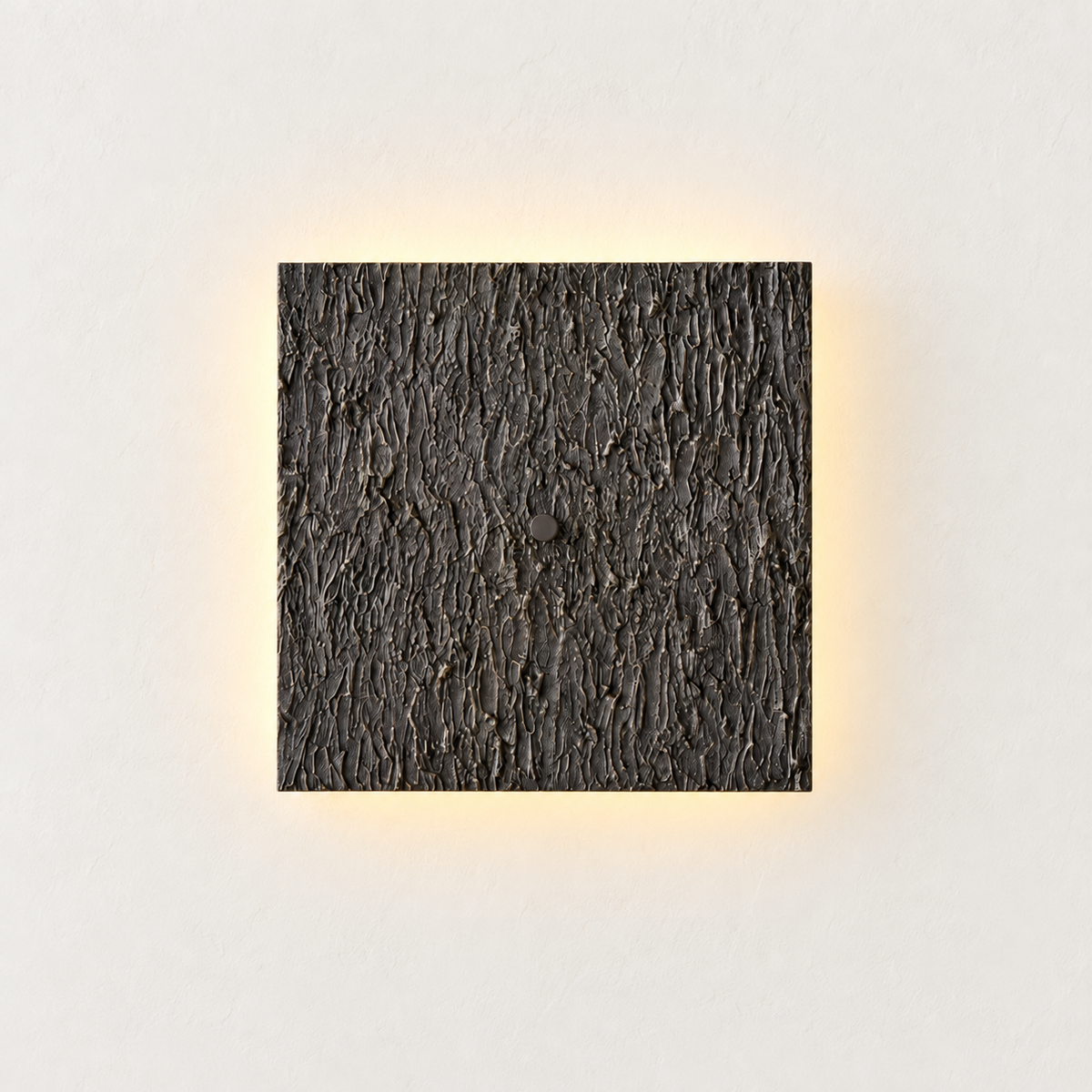 Dark textured square wall sconce with subtle warm backlighting around its edges.